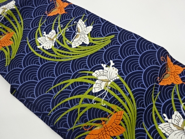 Nagoya obi woven with blue sea waves, grass leaves, and butterfly pattern